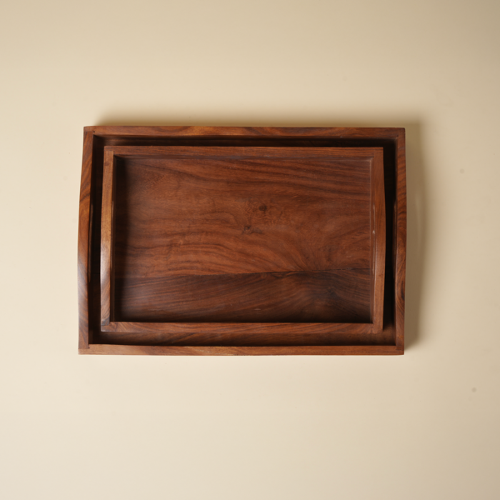 Artisanal wood hosting tray carrying coffee mugs and breakfast items