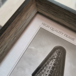 Framed minimalist black and white artwork of a dramatic flatiron-style building perspective for home decor